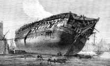 Breaking-up H.M.S. Queen at Rotherhithe, 1871. Creator: Unknown