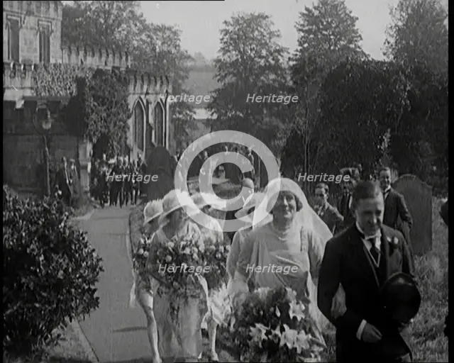 Bride and Groom Walking Through Gardens of Wedding Venue, Followed by Bridesmaids, as Their..., 1921 Creator: British Pathe Ltd.