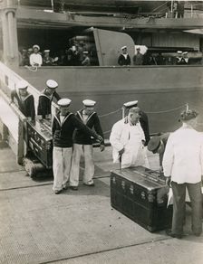 Bringing ashore the steel lined cases from the decks of H.M.S. Hood, July 1935. Creator: Topical Press Agency