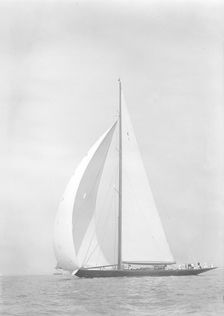 Britannia sails downwind under spinnaker, 1935. Creator: Kirk & Sons of Cowes