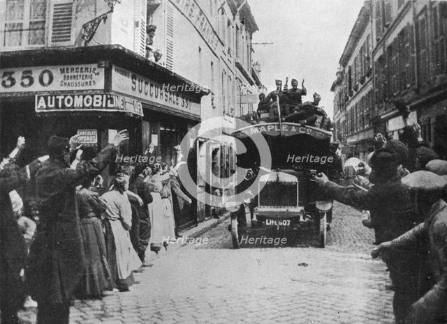 'British troops receive a welcome as they arrive by motor van in a French town', 1915. Artist: Unknown.