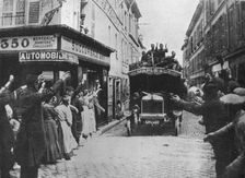 British troops receive a welcome as they arrive by motor van in a French town 1915