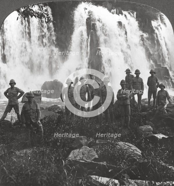 British troops refreshing themselves at a waterfall, Africa, World War I, c1914-c1918. Artist: Realistic Travels Publishers