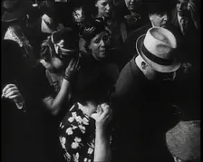 British Women and Men on a Crowded Railway Platform and Several Who Are Looking Upset, 1939. Creator: British Pathe Ltd