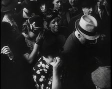 British Women and Men on a Crowded Railway Platform and Several Who Are Looking Upset, 1939. Creator: British Pathe Ltd