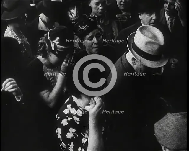 British Women and Men on a Crowded Railway Platform and Several Who Are Looking Upset, 1939. Creator: British Pathe Ltd.