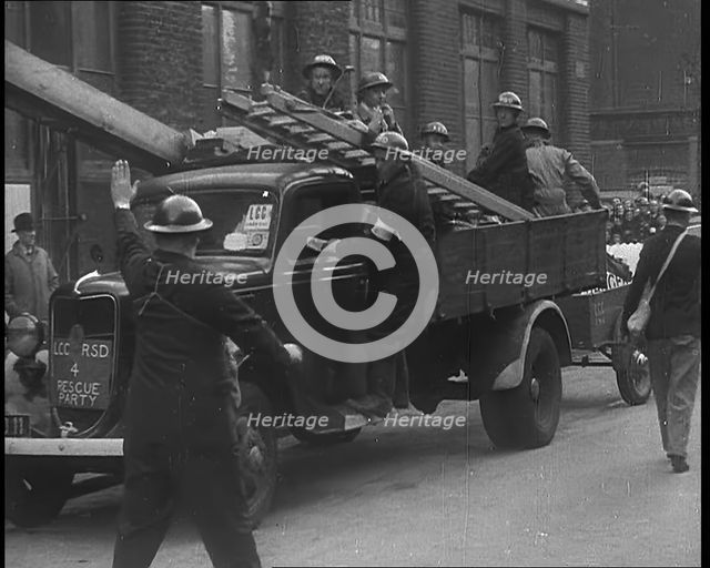 British Air Raid Wardens Arriving at a Phoney Air Raid Scene, 1940. Creator: British Pathe Ltd.