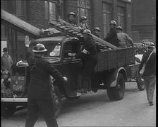 British Air Raid Wardens Arriving at a Phoney Air Raid Scene, 1940. Creator: British Pathe Ltd