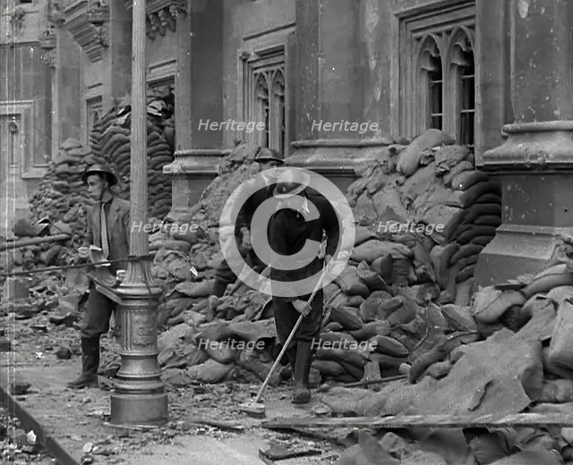 British Air Raid Wardens Clearing up Rubble Around the Palace of Westminster, 1941. Creator: British Pathe Ltd.