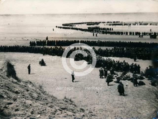 British and French troops wait on the dunes to be evacuated, Dunkirk, 1940. Artist: Unknown