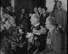 British and Japanese Military Leaders Sitting and Standing Around a Table, 1937. Creator: British Pathe Ltd