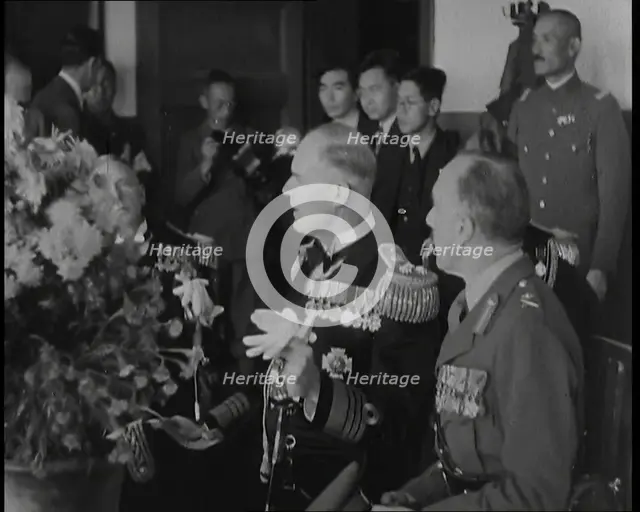 British and Japanese Military Leaders Sitting and Standing Around a Table, 1937. Creator: British Pathe Ltd.