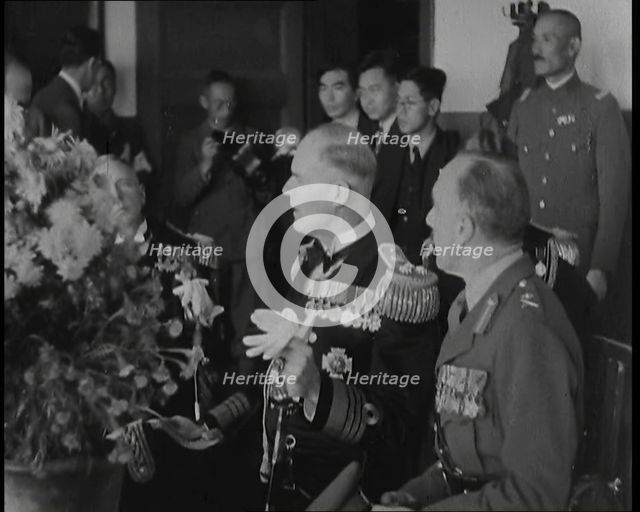 British and Japanese Military Leaders Sitting and Standing Around a Table, 1937. Creator: British Pathe Ltd.