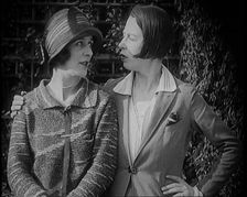 British Artists Norah Blaney and Gwen Farrah Posing for the Camera Smiling at Each Other, 1920. Creator: British Pathe Ltd