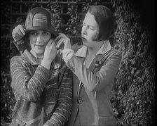 British Artists Norah Blaney and Gwen Farrah Posing for the Camera Smiling at Each Other, 1920. Creator: British Pathe Ltd