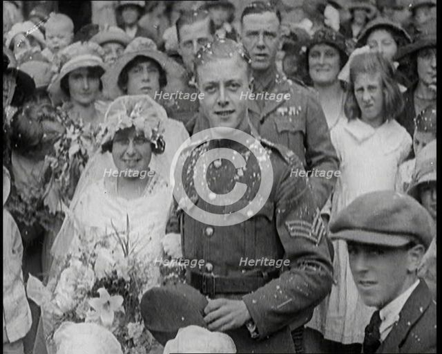 British Bride and Groom Smiling for the Camera at Their Wedding, 1921. Creator: British Pathe Ltd.