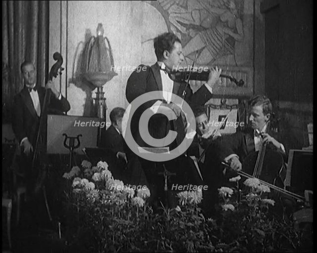 British Celebrated Violinist Albert Sandler, Born Abraham Sandler, Playing the Violin with..., 1920. Creator: British Pathe Ltd.