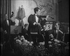 British Celebrated Violinist Albert Sandler, Born Abraham Sandler, Playing the Violin with..., 1920. Creator: British Pathe Ltd