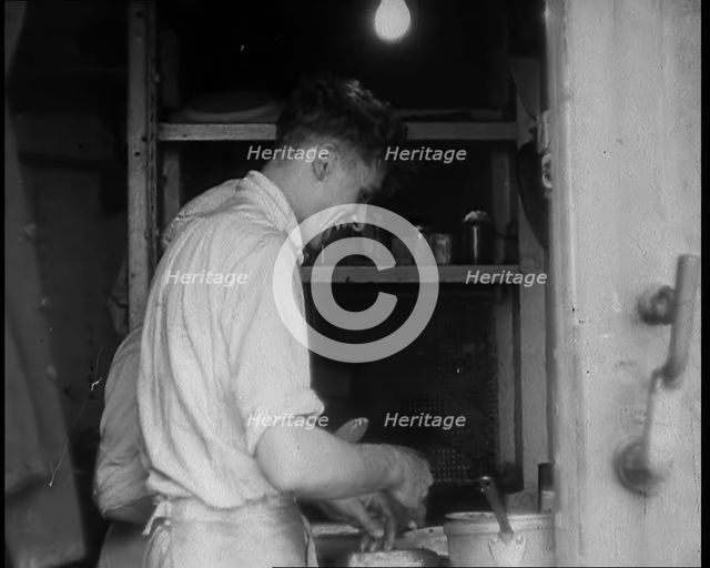 British Cooks Preparing Food for Soldiers Aboard a Ship Evacuating Dunkirk, 1940. Creator: British Pathe Ltd.