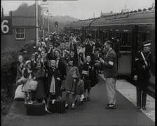 British Male and Female Evacuees on the Platform of a Small Station in the British Country..., 1939. Creator: British Pathe Ltd
