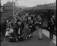 British Male and Female Evacuees on the Platform of a Small Station in the British Country..., 1939. Creator: British Pathe Ltd