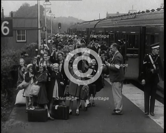British Male and Female Evacuees on the Platform of a Small Station in the British Country..., 1939. Creator: British Pathe Ltd.