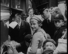 British Male and Female Evacuees Waiting to Board a Bus With Two Male Bus Staff Standing..., 1939. Creator: British Pathe Ltd