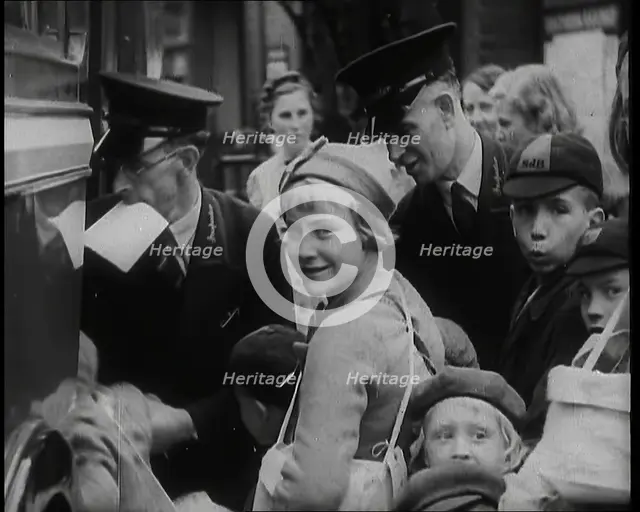 British Male and Female Evacuees Waiting to Board a Bus With Two Male Bus Staff Standing..., 1939. Creator: British Pathe Ltd.