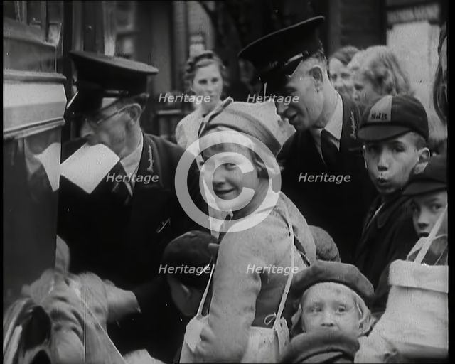 British Male and Female Evacuees Waiting to Board a Bus With Two Male Bus Staff Standing..., 1939. Creator: British Pathe Ltd.