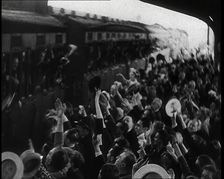 British Men Leaning Out of Railway Carriages and Saying Goodbye to People on a Crowded..., 1939. Creator: British Pathe Ltd