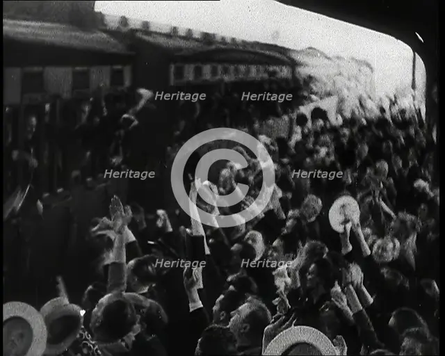 British Men Leaning Out of Railway Carriages and Saying Goodbye to People on a Crowded..., 1939. Creator: British Pathe Ltd.