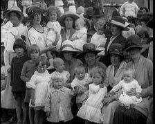 British Mothers Sitting With Their Babies on Their Laps at a Baby Show, 1920. Creator: British Pathe Ltd