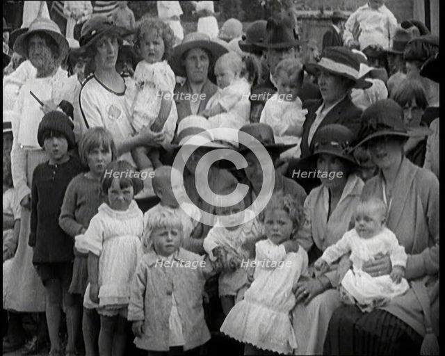 British Mothers Sitting With Their Babies on Their Laps at a Baby Show, 1920. Creator: British Pathe Ltd.