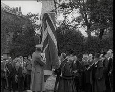 British Officer Pulling Down Union Flag to Reveal a Memorial Obelisk, 1920. Creator: British Pathe Ltd