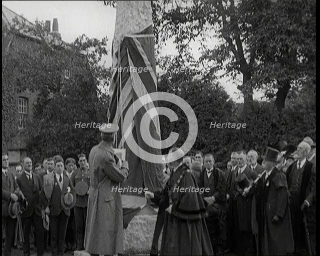 British Officer Pulling Down Union Flag to Reveal a Memorial Obelisk, 1920. Creator: British Pathe Ltd.