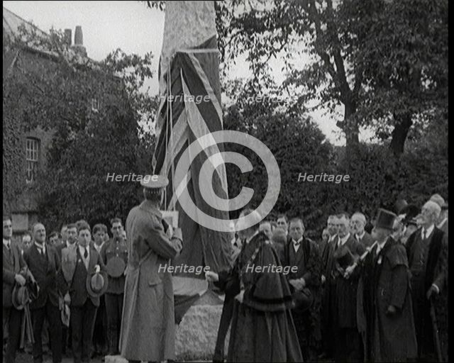 British Officer Pulling Down Union Flag to Reveal a Memorial Obelisk, 1920. Creator: British Pathe Ltd.