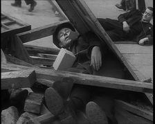 British People Acting Out Bomb attacks and Crashed German Planes, Lying Under Rubble, 1940. Creator: British Pathe Ltd