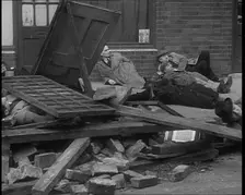 British People Acting Out Bomb attacks and Crashed German Planes, Lying Under Rubble, 1940. Creator: British Pathe Ltd
