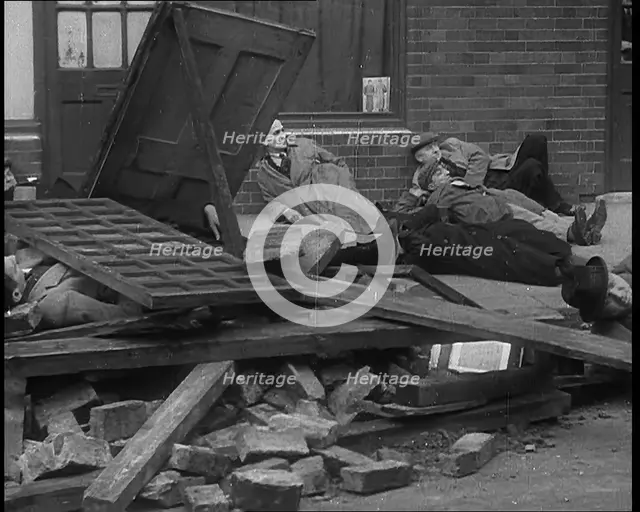 British People Acting Out Bomb attacks and Crashed German Planes, Lying Under Rubble, 1940. Creator: British Pathe Ltd.