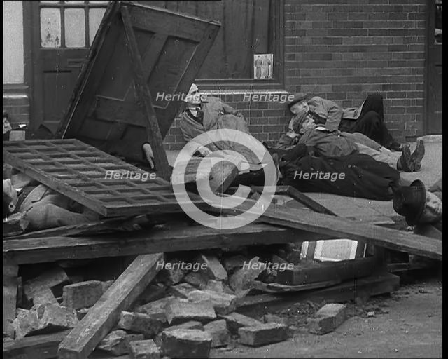 British People Acting Out Bomb attacks and Crashed German Planes, Lying Under Rubble, 1940. Creator: British Pathe Ltd.
