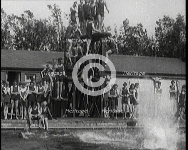 British People Jumping from Various Tiers of Diving Boards at the Chiswick Open Air Baths, 1920. Creator: British Pathe Ltd.