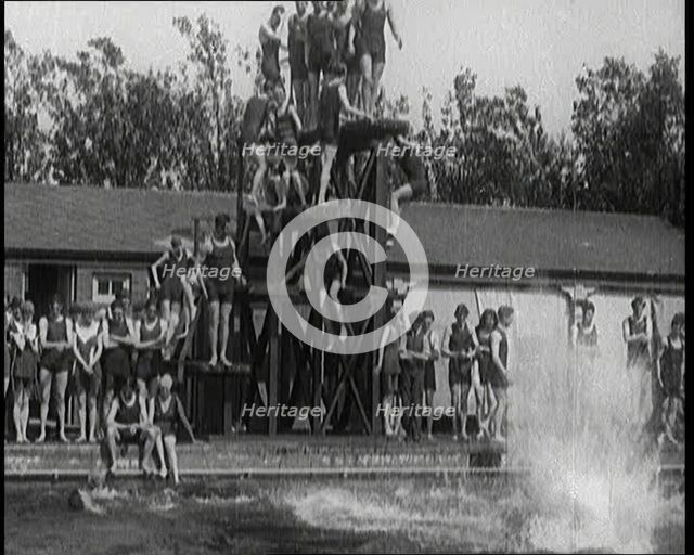 British People Jumping from Various Tiers of Diving Boards at the Chiswick Open Air Baths, 1920. Creator: British Pathe Ltd.