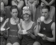 British People Sitting Around and Drinking Cups of Tea While Wearing Bathing Suits at the.., 1920. Creator: British Pathe Ltd