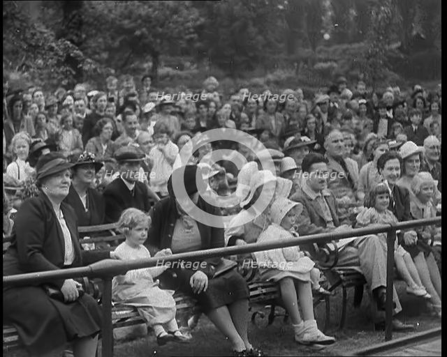 British People Watching Chimpanzees Having a Tea Party at the Zoo, 1940. Creator: British Pathe Ltd.