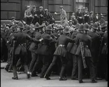 British Police Officers Holding Back Crowds of Demonstrators in Downing Street, London, 1920. Creator: British Pathe Ltd