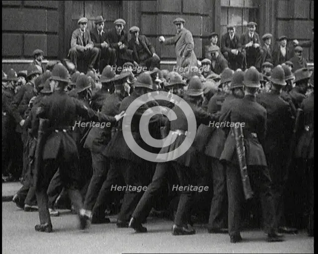 British Police Officers Holding Back Crowds of Demonstrators in Downing Street, London, 1920. Creator: British Pathe Ltd.
