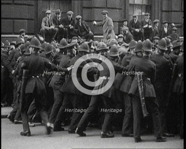 British Police Officers Holding Back Crowds of Demonstrators in Downing Street, London, 1920. Creator: British Pathe Ltd.
