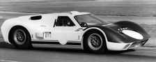 British racing driver and engineer Ken Miles driving a 1966 Ford GT40 J racing car. Creator: Unknown