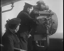 British Royal Navy Officer Looking Through a Telescope With a Searchlight at the Norwegian..., 1940 Creator: British Pathe Ltd