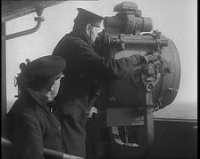 British Royal Navy Officer Looking Through a Telescope With a Searchlight at the Norwegian..., 1940 Creator: British Pathe Ltd
